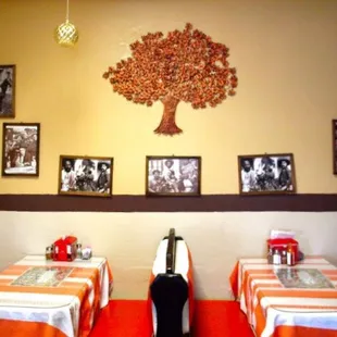 Inside booth seating, great for small groups. Notable Mexican figures decorated along the wall.