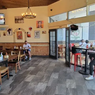 a man standing at a counter in a restaurant