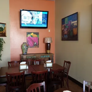 a television mounted above a dining room table