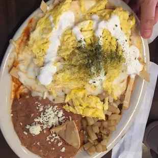 Chilaquiles (tortilla chips) w scrambled eggs.  Good n spicy.