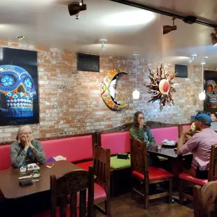 a lot of pictures of decorated skulls in the windowless basement below street level