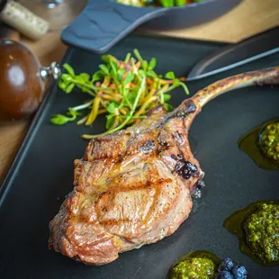 a rack of lamb chops with a side of vegetables