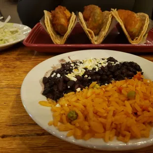 Avocado tacos with rice and beans and slaw on the side