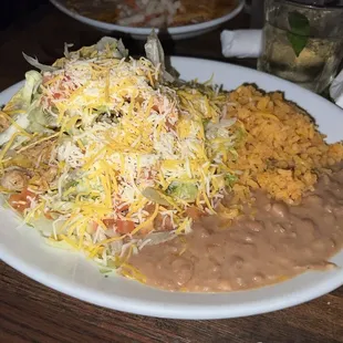 Two chicken tacos with rice and beans