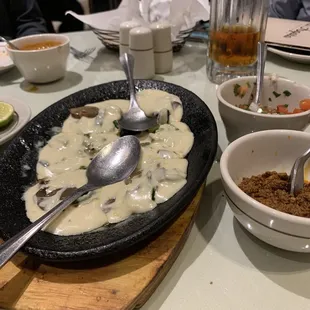 a plate of food and bowls of soup