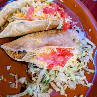 two tacos on an orange plate