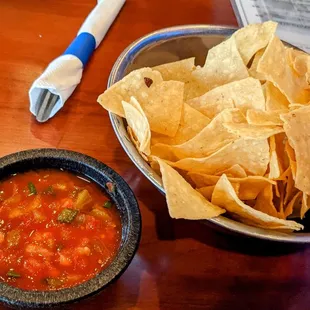 a bowl of chips and a bowl of salsa