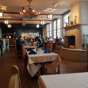 people sitting at tables in a restaurant