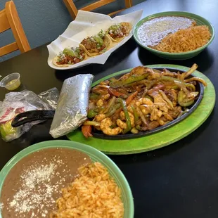 Chorizo and al pastor tacos, side of rice and beans, trio fajitas