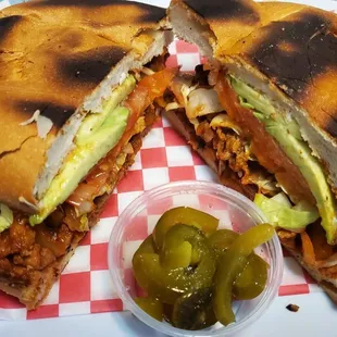 a pulled pork sandwich with pickles