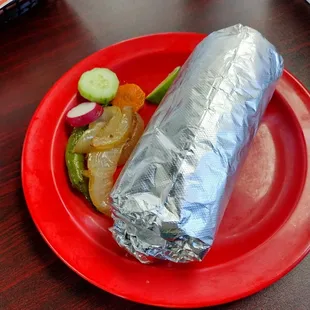 a burrito on a red plate