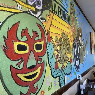 Colorful spirit &amp; cultural traditions depicted on the walls of the dining room.
