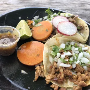 a plate of tacos and a drink