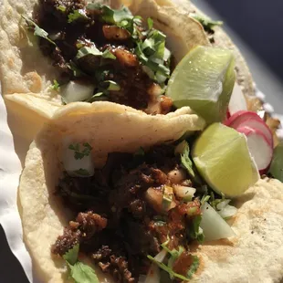 two tacos on a paper plate