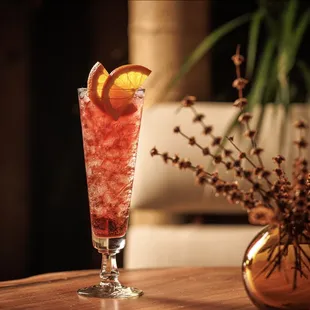 a glass with a drink on a table