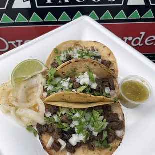 3 Carne Asada Street Tacos - the authentic Mexican way! Onions, cilantro, with a lime on the side. Best served on homemade corn tortillas.