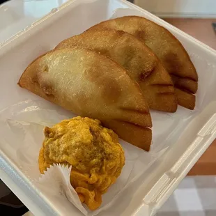 a hand holding a tray of food