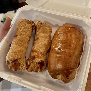 two pastries in a styrofoam container