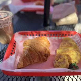 a basket of breakfast items on a table