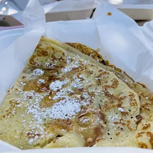 a pancake with powdered sugar on top