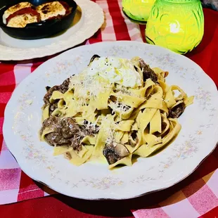 a plate of pasta with meat and cheese