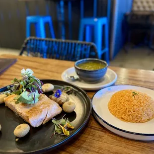 Salmon with mole sauce, enchilada sauce on side.