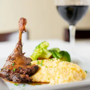 a plate of food and a glass of wine