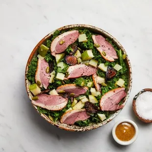 a bowl of salad with meat and vegetables