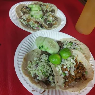 two tacos on a paper plate