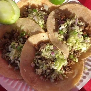 a plate of tacos with two emoticions