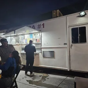 people ordering food from a food truck