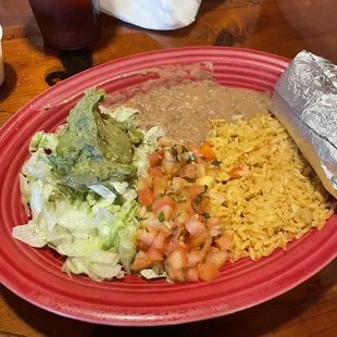 Steak fajitas with rice and beans served with tortillas.
