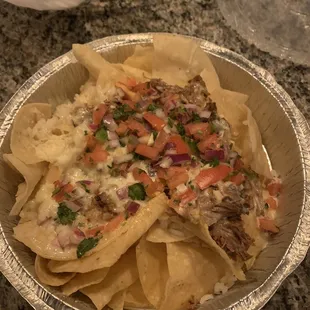 Nachos with shredded beef. White rice. Queso. Pico.