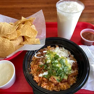 taco bowl with al pastor (marinated pork) and chips and queso and a horchata