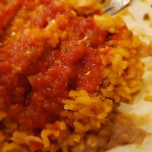 Beans and rice mixed and topped with salsa