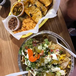 a plate of nachos and a bowl of salad