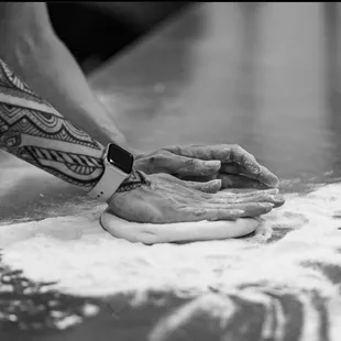 Hand stretching of our pizza dough