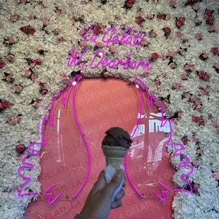 a hand holding an ice cream cone