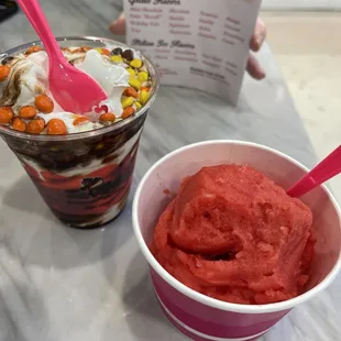 two cups of ice cream and a pink spoon