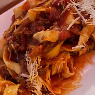 a plate of pasta with meat and cheese