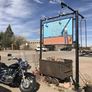 a motorcycle parked in front of a sign