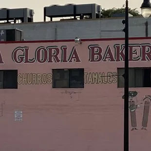 a pink building with a sign on it