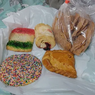 A sprinkle cookie, cherry turnover, cherry pastry, a flag cookie, and a bag of cinnamon sugar tortilla chips
