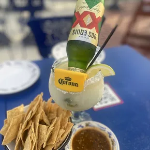 a drink and chips on a table