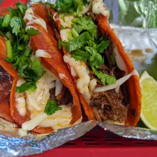 two tacos on a red tray