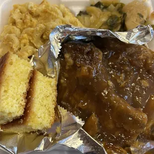 Two smothered chops, mac, cabbage and greens mixed.