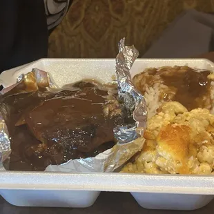 Smothered pork chops rice w/ gravy and macaroni and cheese