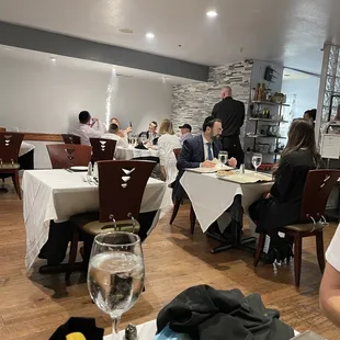 people sitting at tables in a restaurant
