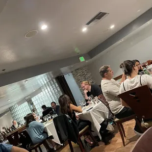 people sitting at tables in a restaurant