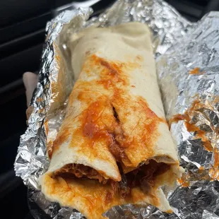 a hand holding a burrito